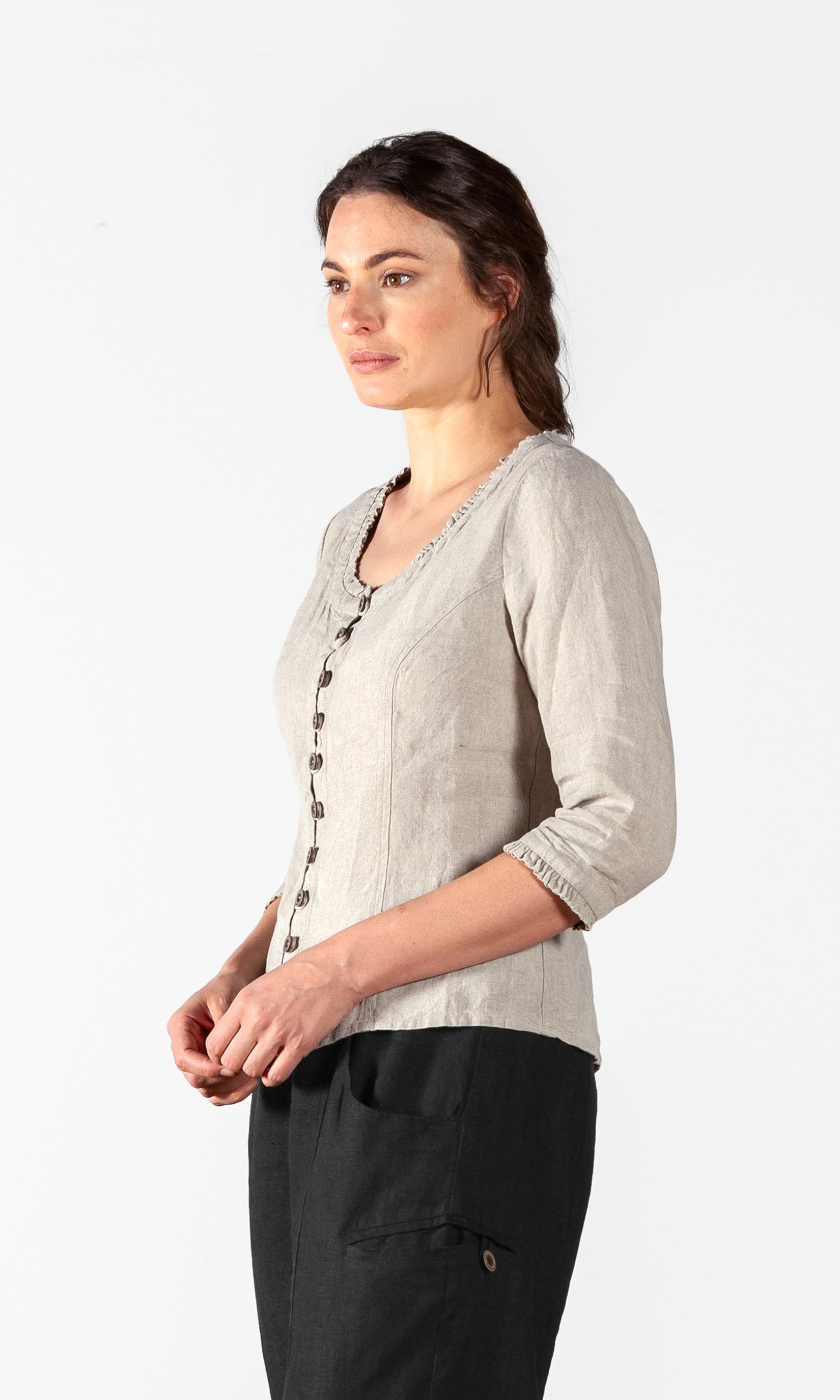 Linen blouse with fastening, ruffle details and three-quarter sleeve