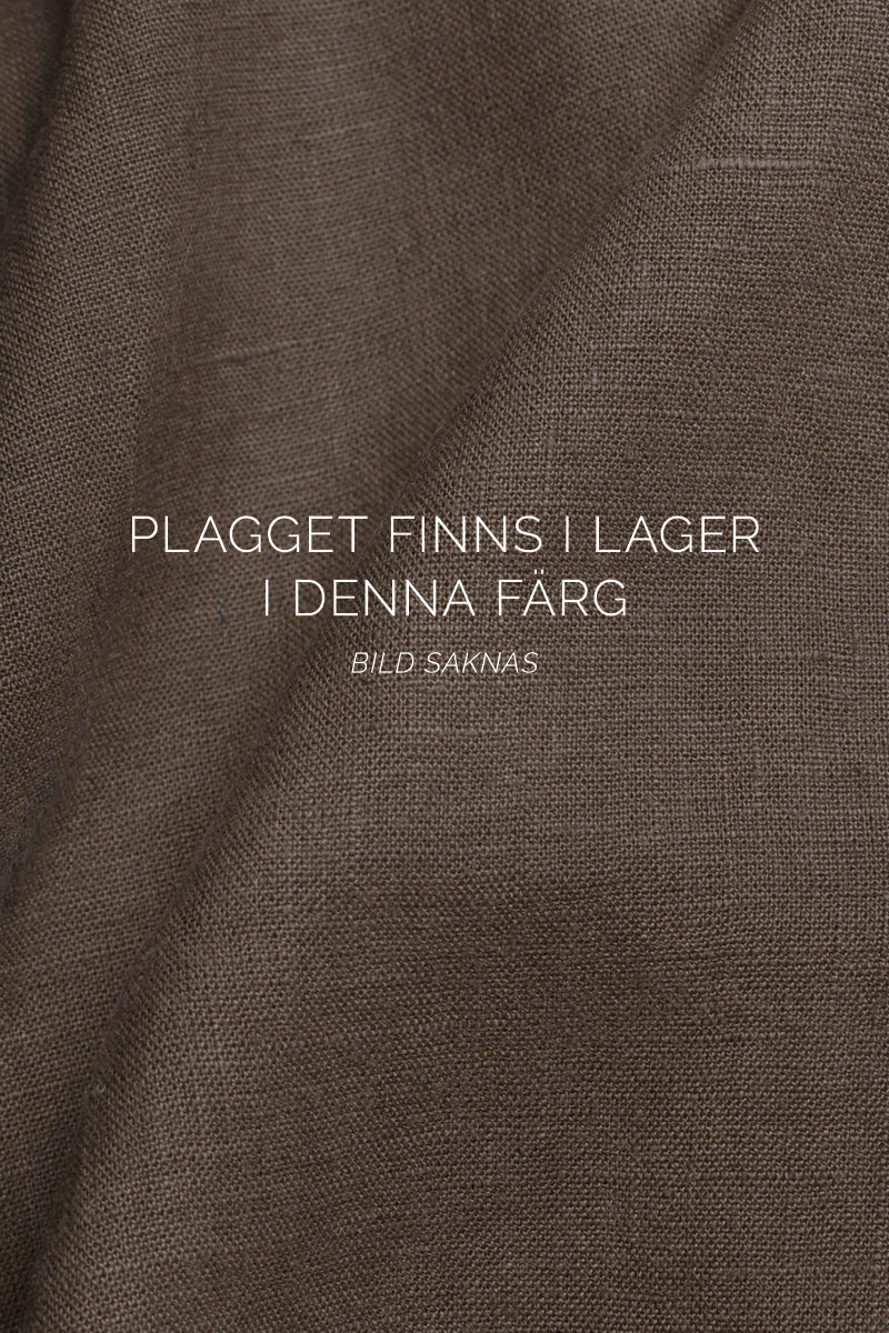 Linnetopp med knappar i ryggen